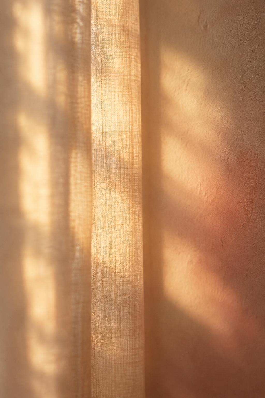 Warm light coming through a linen curtain
